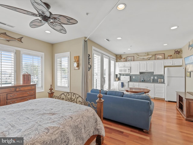 13000 Marina View Ln Unit 25, Ocean City, MD 21842 - bedroom featuring freestanding refrigerator, light wood-type flooring, and recessed lighting