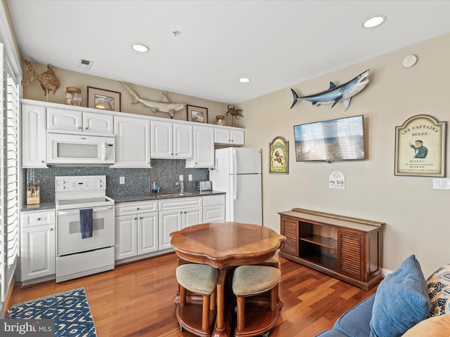13000 Marina View Ln Unit 25, Ocean City, MD 21842 - kitchen with white appliances, a sink, white cabinets, decorative backsplash, and recessed lighting