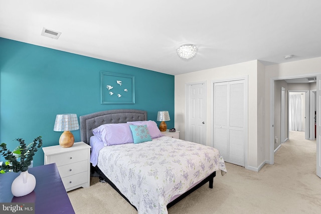 carpeted bedroom featuring baseboards and a closet