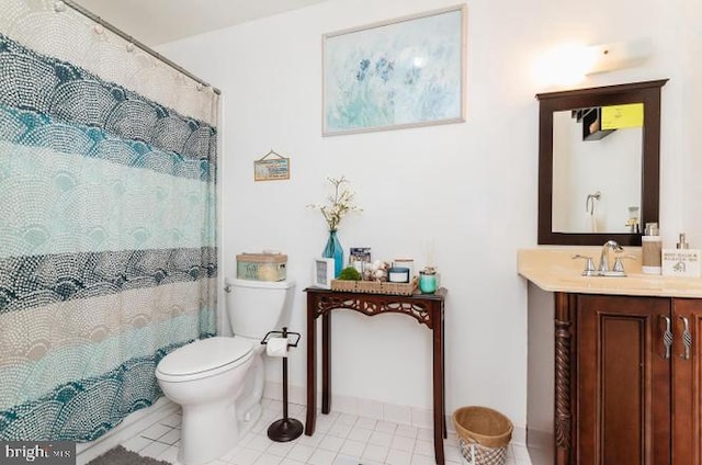 full bath featuring toilet, tile patterned floors, vanity, and baseboards
