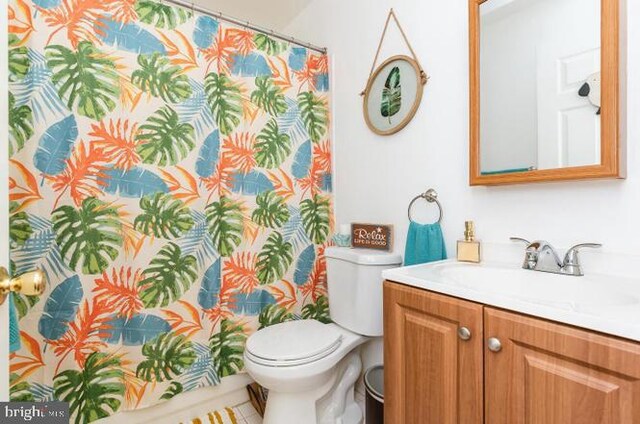 bathroom featuring toilet and vanity