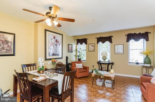 dining area with ceiling fan and baseboards