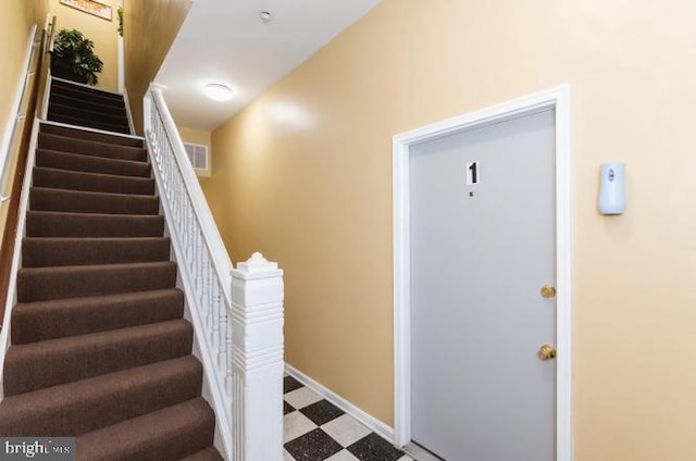 stairs with tile patterned floors