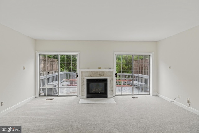 12473 Turtle Dove Pl, Waldorf, MD 20602 - unfurnished living room featuring carpet floors, a tiled fireplace, and healthy amount of natural light