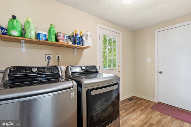 2 Bunting Bridge Rd, Cookstown, NJ 08511 - washroom with washer and clothes dryer, light wood-type flooring, a textured ceiling, and baseboards