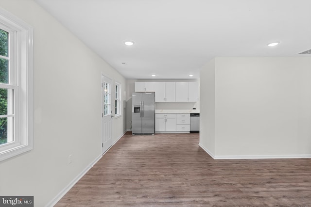 23167 File Rd, Bowling Green, VA 22427 - kitchen with stainless steel appliances, plenty of natural light, white cabinetry, wood finished floors, and recessed lighting