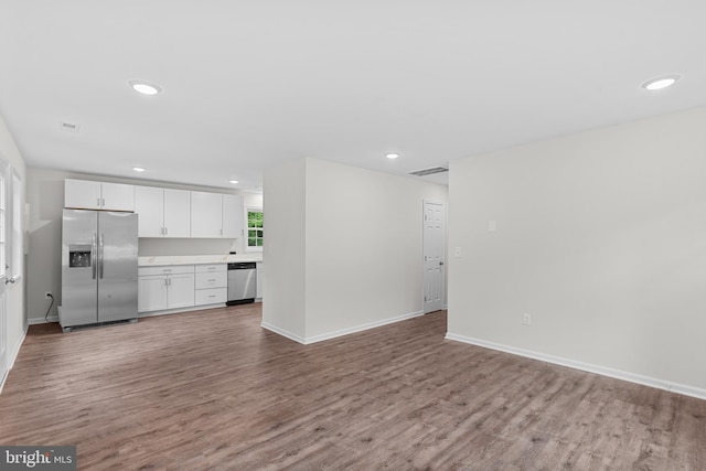 23167 File Rd, Bowling Green, VA 22427 - kitchen featuring stainless steel appliances, wood finished floors, white cabinets, recessed lighting, and open floor plan