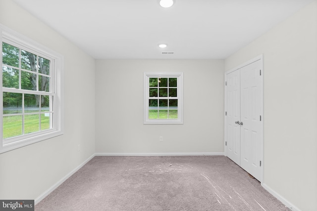 23167 File Rd, Bowling Green, VA 22427 - unfurnished bedroom featuring carpet flooring, multiple windows, and a closet