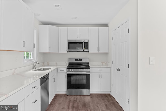 23167 File Rd, Bowling Green, VA 22427 - kitchen featuring appliances with stainless steel finishes, white cabinets, and wood finished floors