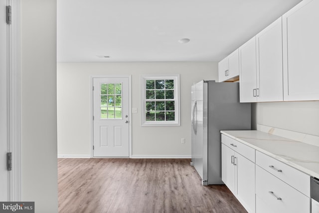 23167 File Rd, Bowling Green, VA 22427 - kitchen featuring wood finished floors, freestanding refrigerator, white cabinets, and light stone countertops