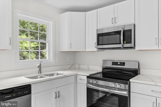 23167 File Rd, Bowling Green, VA 22427 - kitchen featuring appliances with stainless steel finishes, white cabinets, and light stone counters
