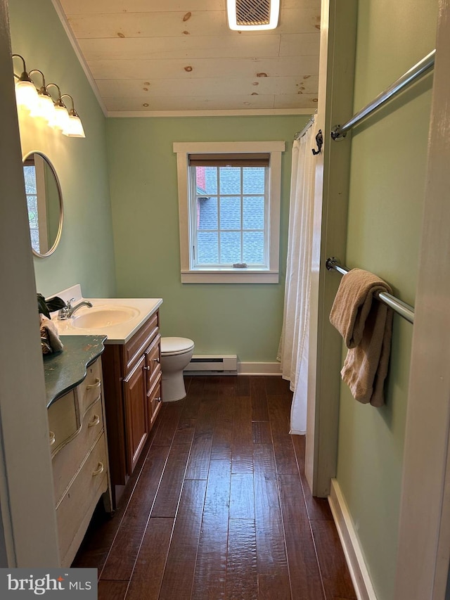 full bath featuring wood-type flooring, a baseboard radiator, visible vents, vanity, and ornamental molding