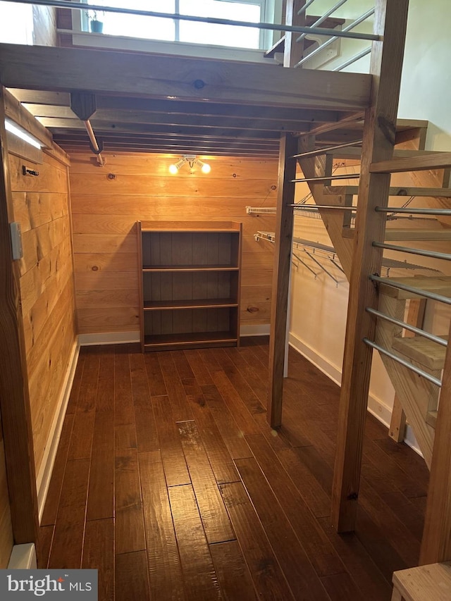 1343 Penns Creek Rd, Coburn, PA 16832 - below grade area featuring dark wood-style floors, wood walls, and baseboards