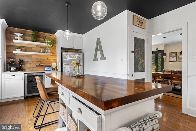 kitchen featuring open shelves, butcher block countertops, hardwood / wood-style floors, and wine cooler
