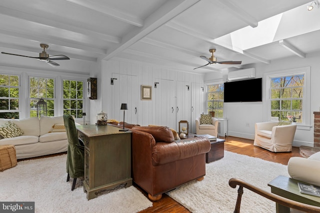 living room with beam ceiling, wood finished floors, and ceiling fan