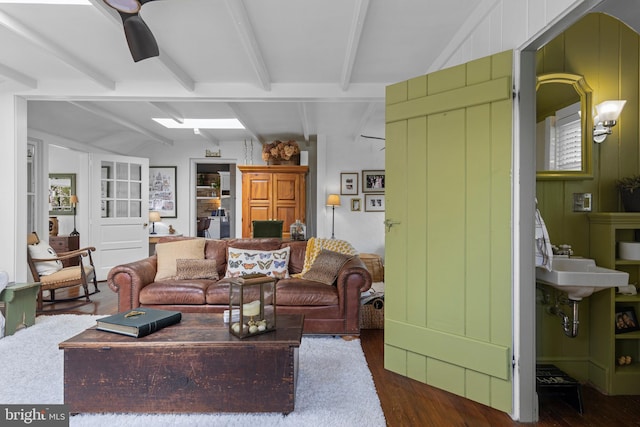 living room with dark wood-type flooring and lofted ceiling with beams