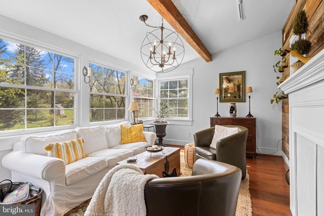 living area featuring baseboards, a wealth of natural light, a notable chandelier, and wood finished floors