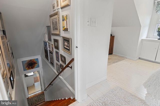 stairs featuring baseboards and wood-type flooring