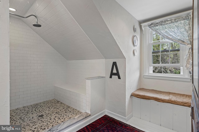 additional living space featuring vaulted ceiling and baseboards