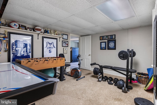 recreation room with a paneled ceiling and carpet floors