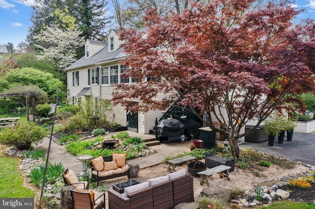 exterior space with an outdoor living space with a fire pit and a patio area