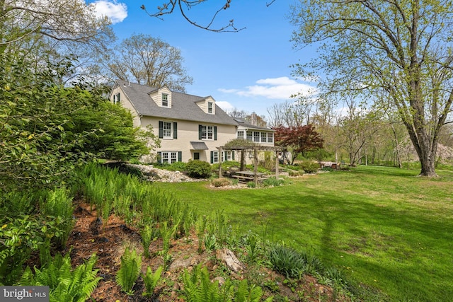 rear view of house with a lawn