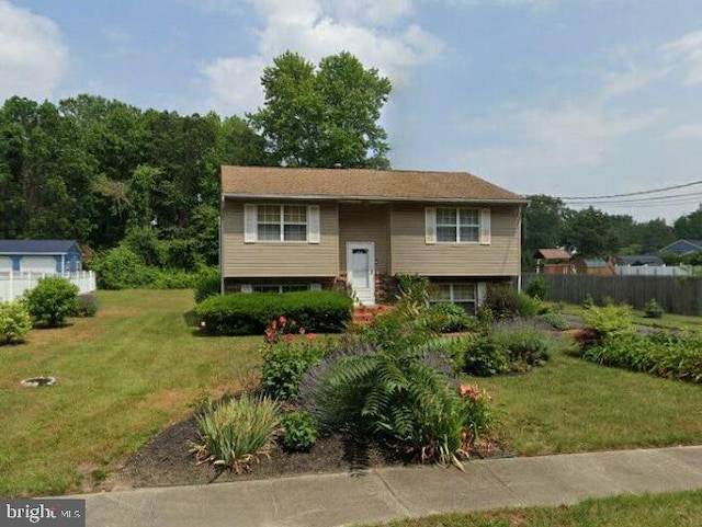 bi-level home with fence and a front yard