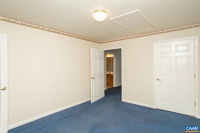 unfurnished bedroom featuring attic access, dark colored carpet, and baseboards