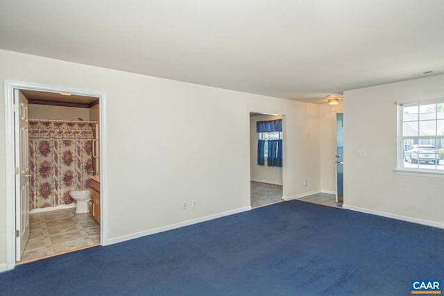 carpeted spare room with baseboards
