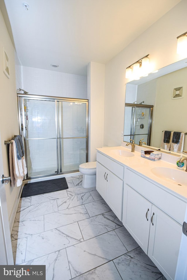 bathroom with marble finish floors, a shower stall, double vanity, and toilet