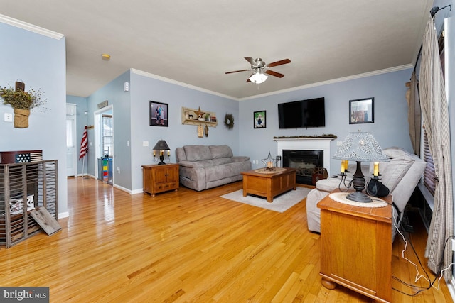 3 Oleander Dr, Stafford, VA 22554 - living room with a fireplace, crown molding, a ceiling fan, and light wood-style floors