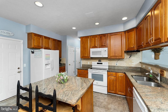 3 Oleander Dr, Stafford, VA 22554 - kitchen featuring a sink, brown cabinetry, white appliances, and light stone counters