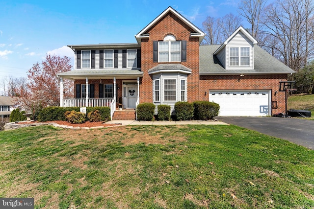 3 Oleander Dr, Stafford, VA 22554 - traditional-style house featuring a porch, a front yard, brick siding, and driveway