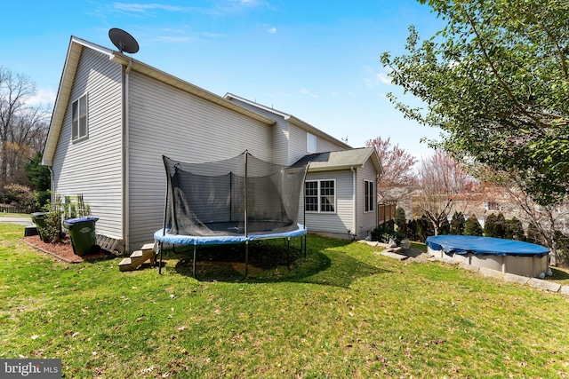 3 Oleander Dr, Stafford, VA 22554 - back of property featuring a covered pool, a trampoline, and a lawn