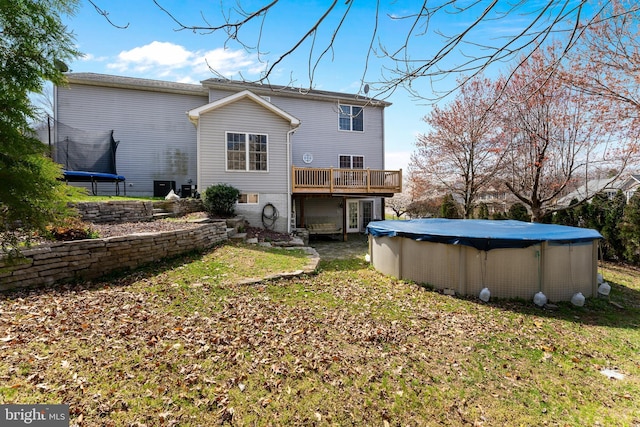 3 Oleander Dr, Stafford, VA 22554 - back of property featuring a trampoline, a yard, a deck, and a covered pool