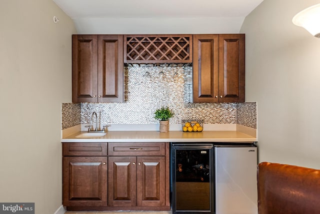 indoor bar featuring wine cooler and tasteful backsplash