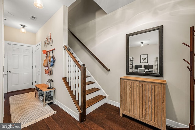 staircase with wood finished floors and baseboards