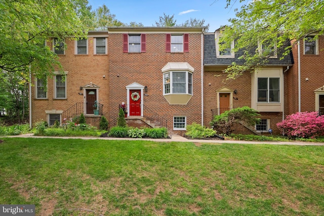 1949 Catoctin Ter, Silver Spring, MD 20906 - view of front facade with a front yard, brick siding, and roof with shingles