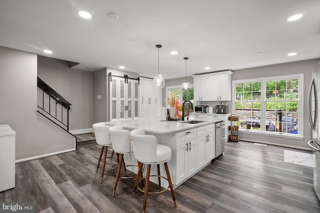 1949 Catoctin Ter, Silver Spring, MD 20906 - kitchen featuring a barn door, a sink, recessed lighting, stainless steel appliances, and white cabinets