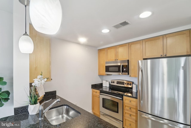 2001 15th St N Unit 207, Arlington, VA 22201 - kitchen featuring a sink, stainless steel appliances, dark stone countertops, visible vents, and recessed lighting