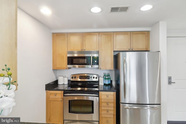 2001 15th St N Unit 207, Arlington, VA 22201 - kitchen featuring recessed lighting, dark stone countertops, visible vents, and appliances with stainless steel finishes