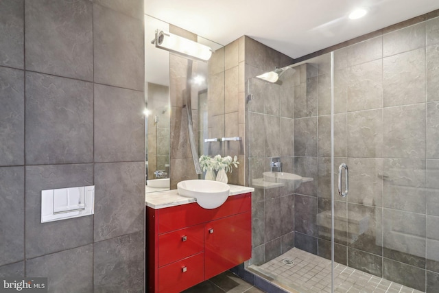 2001 15th St N Unit 207, Arlington, VA 22201 - bathroom with tile patterned floors, tile walls, vanity, and a stall shower