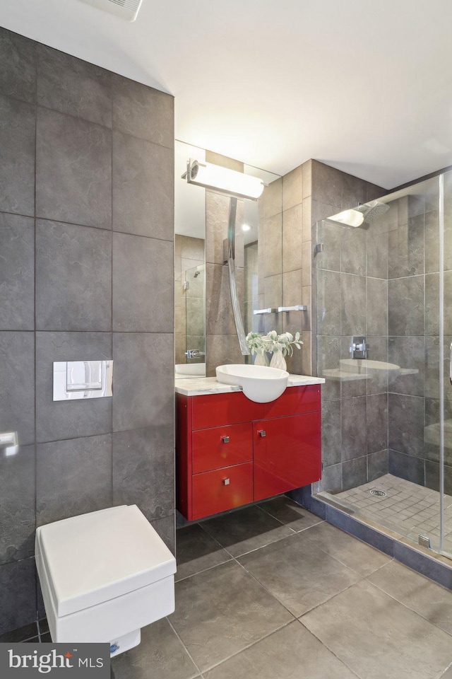 2001 15th St N Unit 207, Arlington, VA 22201 - bathroom with tile patterned floors, tile walls, vanity, and a stall shower