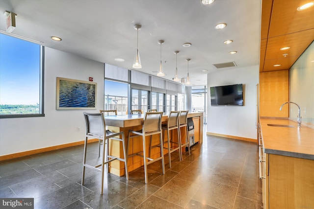 2001 15th St N Unit 207, Arlington, VA 22201 - kitchen with a sink, recessed lighting, granite finish floor, baseboards, and modern cabinets