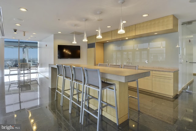 2001 15th St N Unit 207, Arlington, VA 22201 - kitchen featuring granite finish floor, recessed lighting, decorative light fixtures, modern cabinets, and a kitchen bar