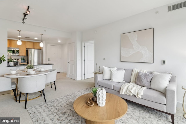 2001 15th St N Unit 207, Arlington, VA 22201 - living room featuring track lighting, recessed lighting, visible vents, and light carpet