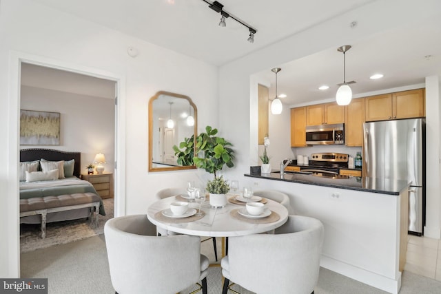 2001 15th St N Unit 207, Arlington, VA 22201 - kitchen featuring dark countertops, track lighting, decorative light fixtures, appliances with stainless steel finishes, and recessed lighting
