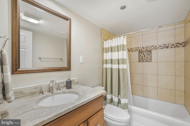 bathroom with toilet, vanity, and shower / bath combo with shower curtain