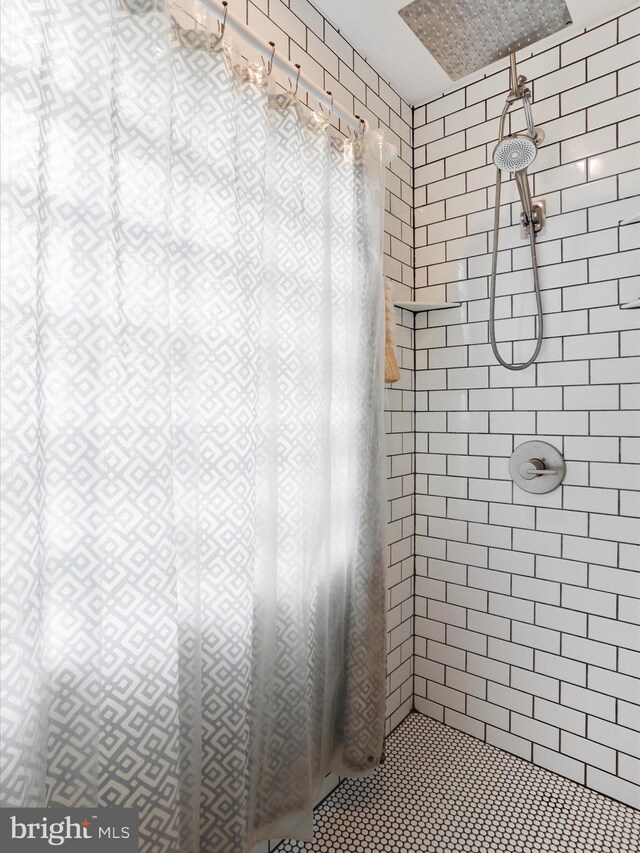 full bathroom with tiled shower