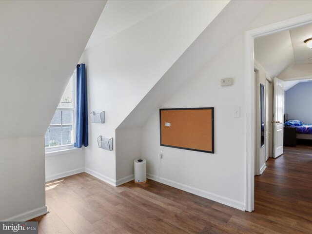 bonus room featuring vaulted ceiling, wood finished floors, and baseboards